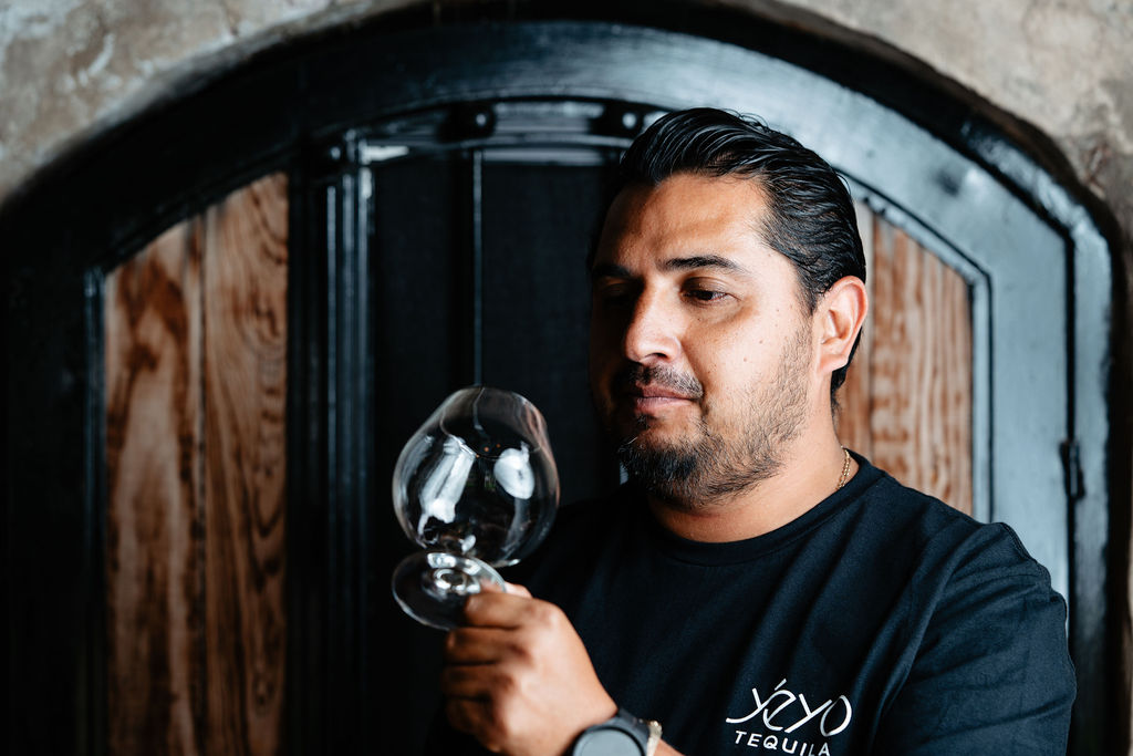 Sergio Cruz Sr. examining a tasting glass in the distillery